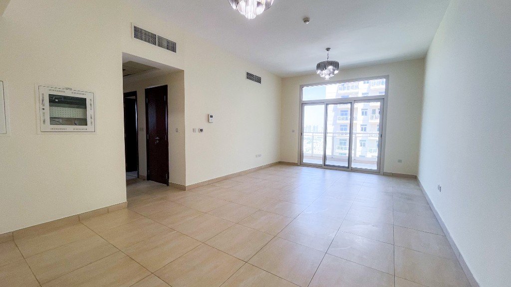 Vacant living room with balcony doors in the Azizi Freesia apartment