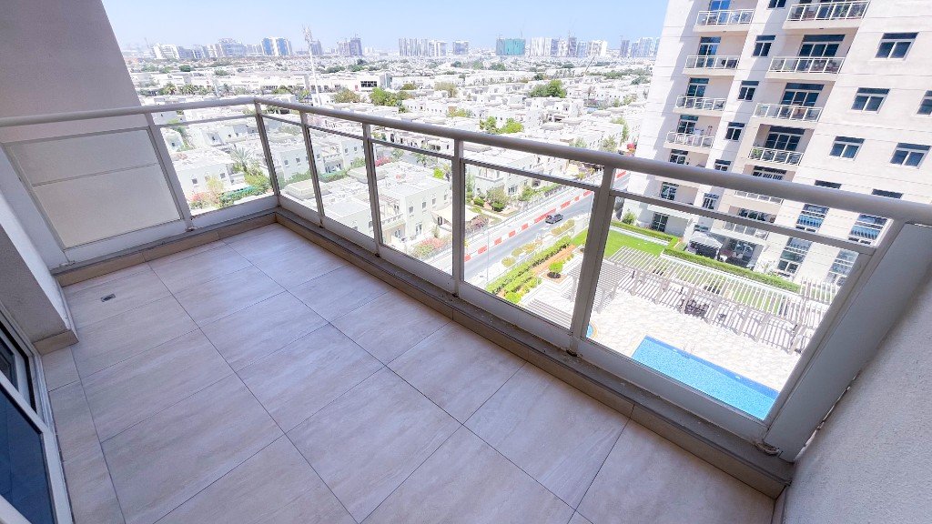 Balcony at Azizi Freesia overlooking the swimming pool and Al Furjan