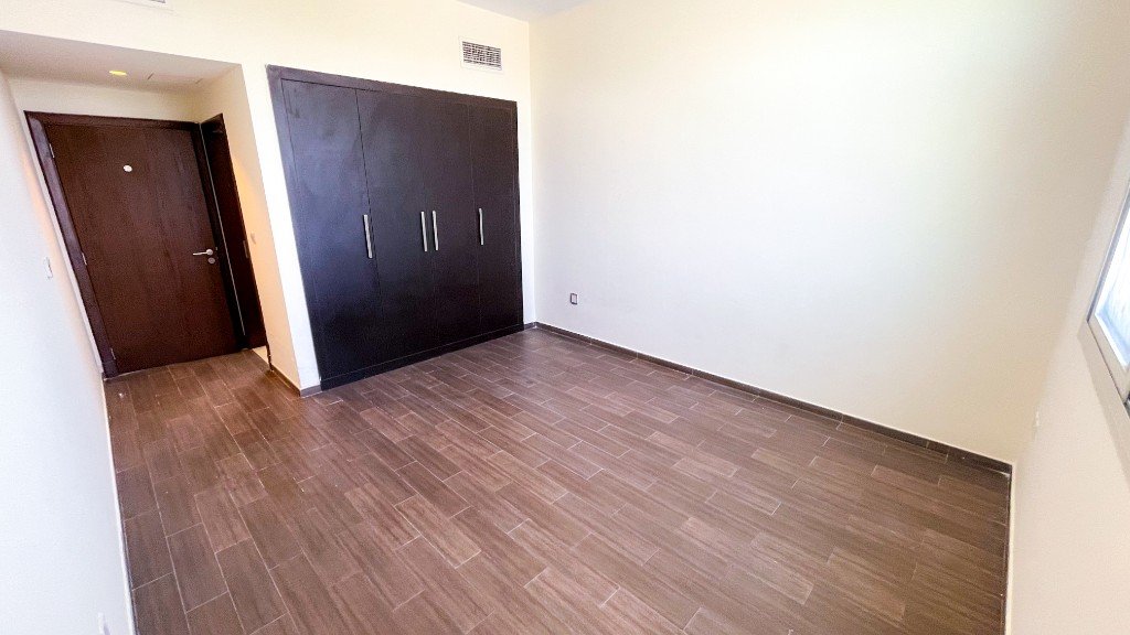 Room with built-in wardrobes in the Azizi Freesia apartment